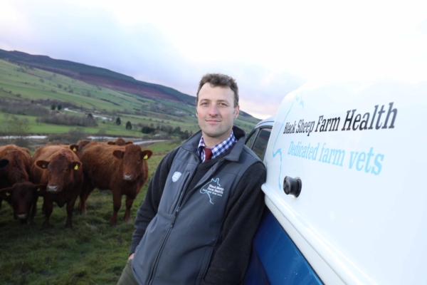 Image of Joe Henry beside some cattle